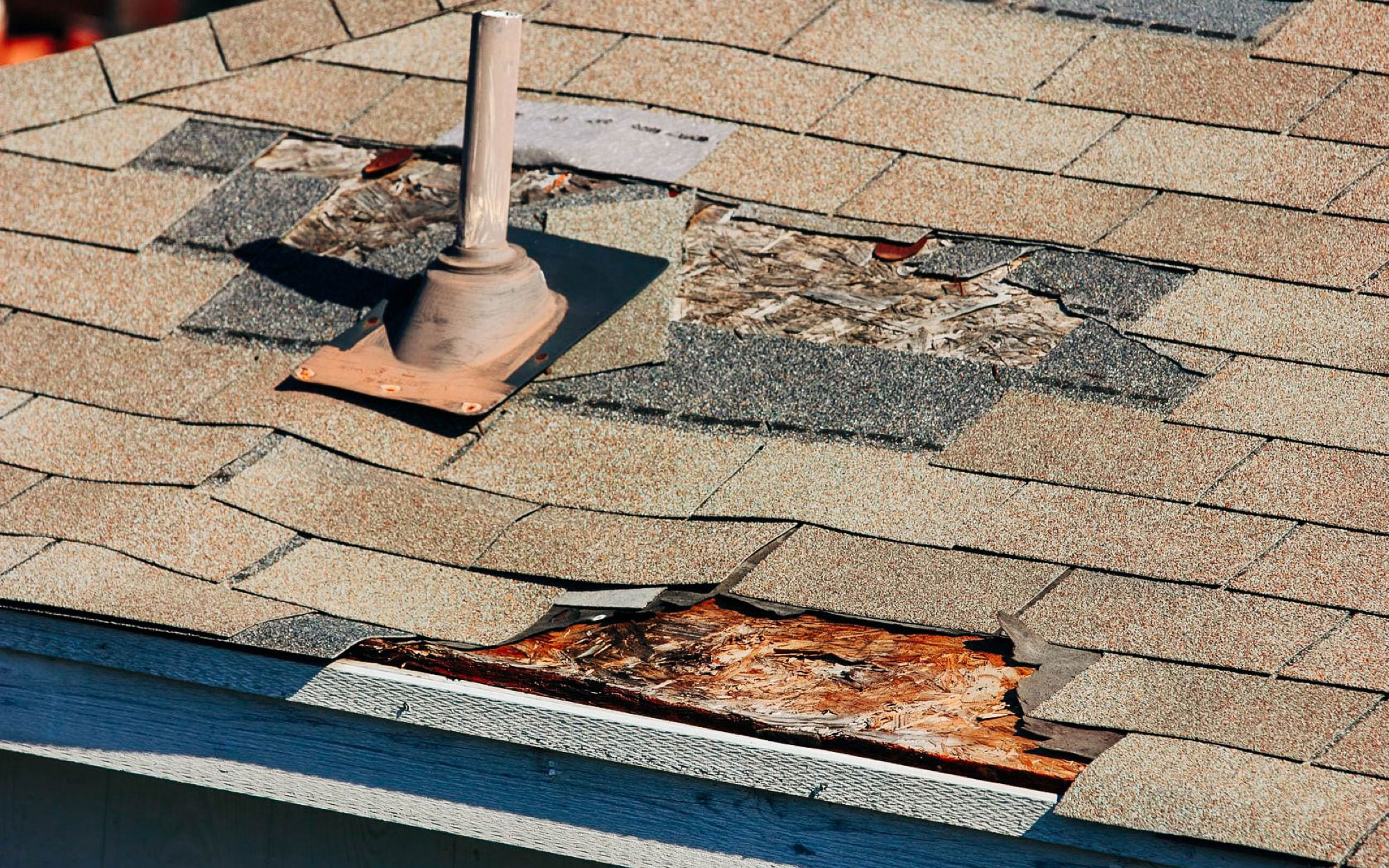 Badly damaged roof and shingles